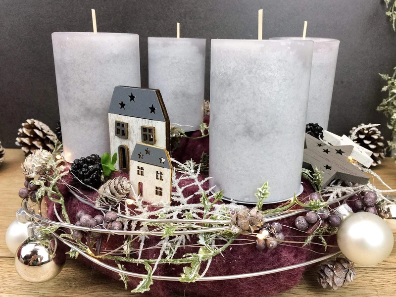 Runder Adventskranz mit Häusern und LED-Lichterkette